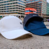 ART print on white, black, and jeans coloured cap.